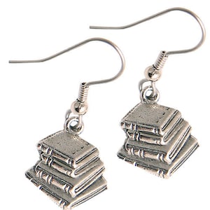 May include: Silver earrings shaped like a stack of books. Each earring features four books with detailed edges and a silver hook.