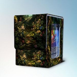 May include: A rectangular deck box for trading cards featuring a vibrant forest path illustration with green foliage, colorful flowers, and blue butterflies. The side panel includes a clear window displaying a card with visible text and artwork.