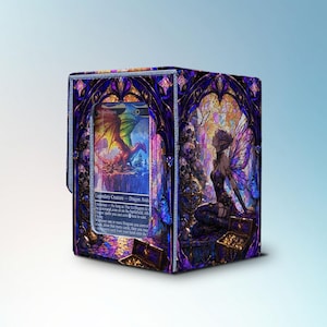 May include: A cube-shaped card storage box with a stained-glass design. The box features a colorful illustration of a dragon and a fairy. The box is primarily purple and blue with gold accents.