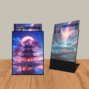 May include: A black card holder with a landscape image of a pagoda, a full moon, and a body of water. The card holder is holding a card with the text "Morphic Pool". The card has a black border.