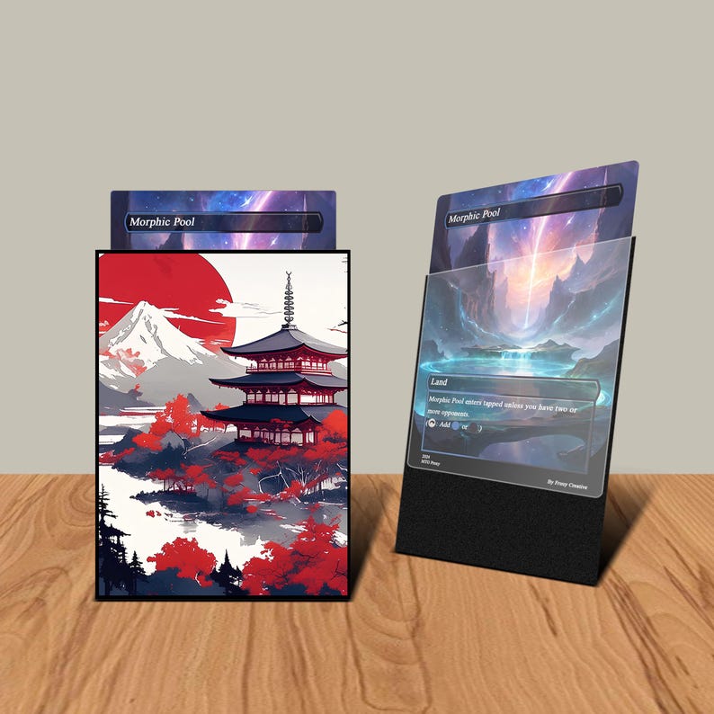May include: A black card holder and a card featuring a Japanese landscape design. The card holder has a black base and displays a card with a mountain and pagoda scene. The card on the right has a landscape scene with the text "Morphic Pool".