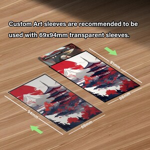 May include: Custom art sleeves with a Japanese design, featuring a red sun, pagodas, and trees. The sleeves measure 6.9cm x 9.4cm and 6.6cm x 9.1cm. Text on the image recommends using transparent sleeves.