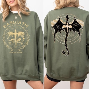 a woman wearing a green sweatshirt with a picture of a dragon on it
