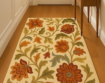 May include: Rectangular floral rug with a cream background and a repeating pattern of large orange and red flowers with green and gray leaves. The rug is placed in a hallway with a wooden floor.