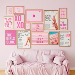May include: A collection of framed art prints in shades of pink and white, featuring various text-based designs and images. The prints include phrases like "Love," "XO," and "The Girls Club," along with images of high heels and a playing card.
