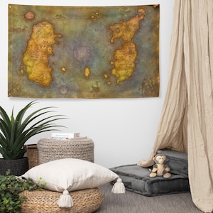 May include: A large, rectangular tapestry featuring a detailed map with landmasses in shades of yellow, orange, and brown, set against a blue-green ocean. The map has text labels and a central spiral design. The tapestry is hanging on a white wall.