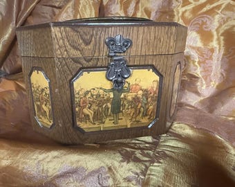 May include: Wooden box with a hinged lid and metal clasp. The box is decorated with a framed image of an orchestra. The box has a light brown wood grain finish.