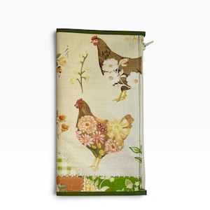 May include: A rectangular fabric pouch featuring a cream-colored background with a pattern of two brown chickens adorned with white and yellow floral designs. The pouch has a dark green fabric trim along the edges and a visible zipper on the right side.