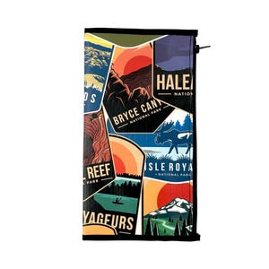 May include: A rectangular zippered pouch featuring a colorful collage of National Park graphic prints, including Bryce Canyon, Haleakala, Isle Royale, and Voyageurs. The design displays stylized landscapes, mountains, forests, and a moose silhouette.