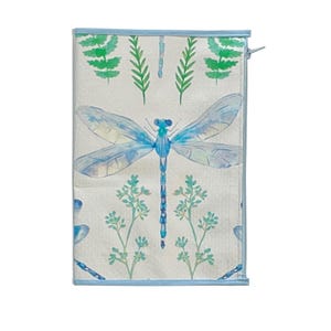 May include: A rectangular, off-white fabric item with a blue dragonfly design. The dragonfly is centered, with light blue wings and a blue body. Green fern and floral accents are at the top and bottom. The edges are trimmed with a light blue border.
