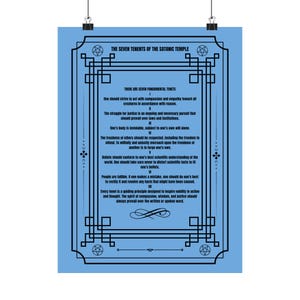 May include: A light blue poster with black text and decorative borders. The text reads "THE SEVEN TENENTS OF THE SATANIC TEMPLE" and lists seven tenets. The poster is held by two black clips.