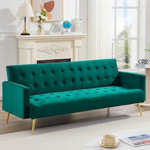 May include: A green velvet sofa with gold-coloured legs. The sofa has a button-tufted back and seat, and gently sloped arms. The sofa is a modern piece of furniture.