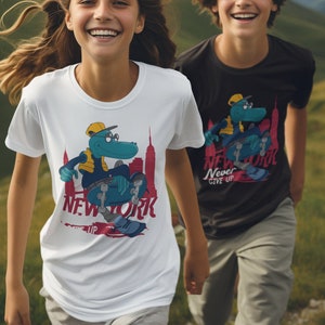 May include: Two people wearing t-shirts with a cartoon alligator skateboarding and the words "New York" and "Never Give Up". The people are standing in a grassy field with mountains in the background.