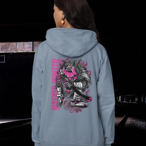 May include: A light blue hooded sweatshirt featuring a graphic on the back of a pink-skinned, horned character holding a sword. The character wears dark clothing and sneakers, with the text "MASKED HUNTER" printed vertically in pink next to it.
