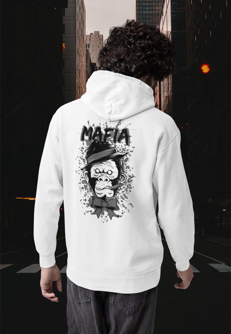 May include: A white hooded sweatshirt featuring a graphic on the back of a gorilla wearing a fedora hat and a bow tie with a cigar in its mouth. Above the gorilla, the word MAFIA is printed in bold black letters against a grey paint splatter.