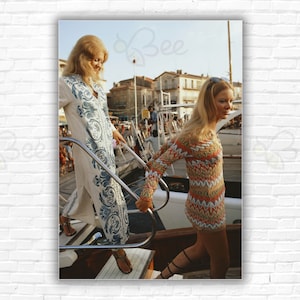 Slim Aarons Saint-Tropez Print/Poster - Two young women one wearing a kaftan stepping onto a yacht on the waterfront at Saint-Tropez France