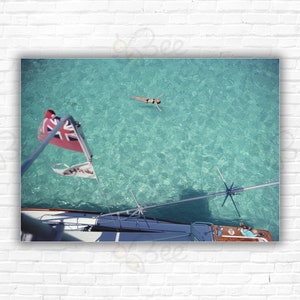 Slim Aarons  Swimming In Bermuda Print/Poster: Guests on Sidney Gould's 'Sea Quest' boat take a dip in the ocean, Bermuda, September 1977.