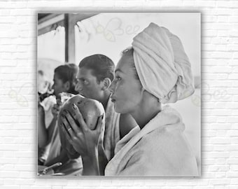 Slim Aarons Refreshments in Jamaica Print/Poster: Liz Pringle drinking from a coconut at Round Hill, Montego Bay, Jamaica, 1953