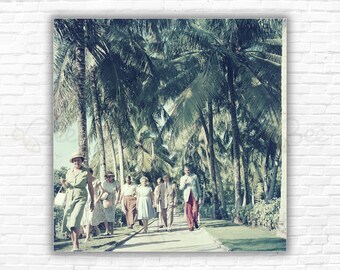 Slim Aarons  Bahamas Palm Trees Print/Poster - A group of people walking along a path, in the shade of palm trees, in Bahamas, circa 1957.