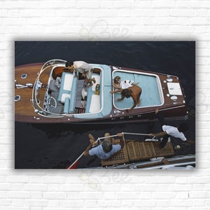 Stampa/Poster "All Aboard" di Slim Aarons: gli amici salgono a bordo di una barca Riva a Monte Carlo, Monaco, 1975.