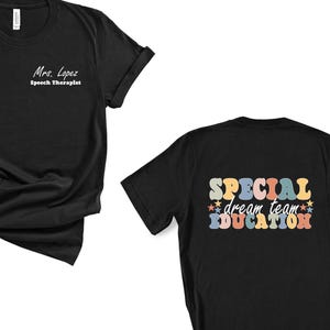 May include: Black t-shirt with the text "Mrs. Lopez, Speech Therapist" on the front. The back of the shirt features the words "SPECIAL dream team EDUCATION" in a retro font with colorful stars.