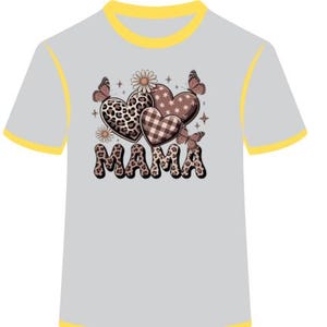May include: A light gray t-shirt with yellow trim. The shirt features a graphic of three hearts with different patterns, including leopard print and plaid. The word "MAMA" is printed below the hearts in a decorative font, and butterflies are also included in the design.