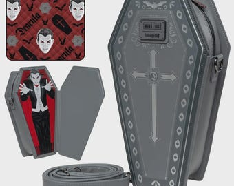 May include: Gray coffin-shaped crossbody bag with a silver cross design and a bat emblem. The bag features a zipper closure and a detachable shoulder strap. A smaller bag with a Dracula design is also shown.