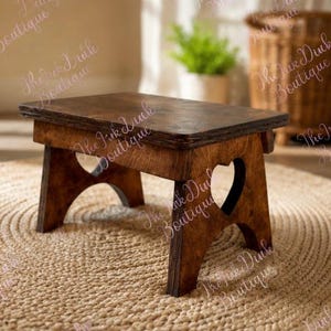 May include: A small, dark-stained wooden step stool. The stool has a rectangular top and heart-shaped cutouts on the sides. It is placed on a woven, circular rug. The wood grain is visible, and the stool appears sturdy.