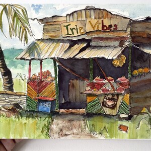 May include: A watercolor painting of a small, wooden shop with a sign that reads "Irie Vibes". The shop is located on a beach and has a variety of fruits and vegetables for sale. There is a palm tree in the background.