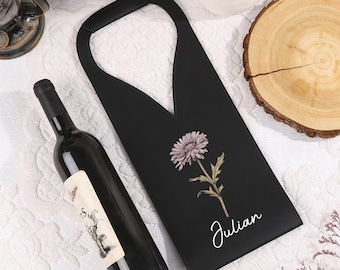 May include: Black wine bottle holder with a floral design and the name "Julian" printed in white.