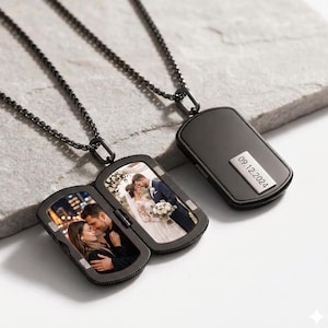 May include: Two black metal dog tag pendants on matching chains. One pendant is closed, displaying the engraved date 09.12.2024. The other pendant is open, revealing two interior photo inserts showing a couple in a wedding setting.