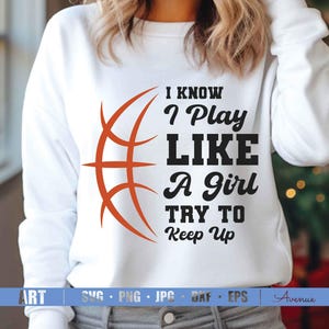 May include: White sweatshirt with a basketball graphic and the text "I KNOW I Play LIKE A girl TRY TO Keep Up".