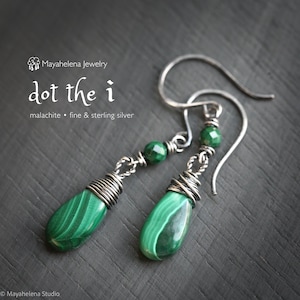 May include: A pair of handcrafted earrings featuring teardrop-shaped malachite stones with a vibrant green pattern. The stones are accented with fine sterling silver wire and small green beads. The earrings are designed with a hook closure.