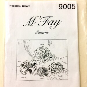 May include: A black and white line drawing of four different rosettes, labeled View A, View B, View C, and View D. The drawing is on a white sheet of paper with the text "Rosettes Galore", "9005", "M'Fay Patterns", and "This is a Professional Drapery Workroom Pattern" printed on it.
