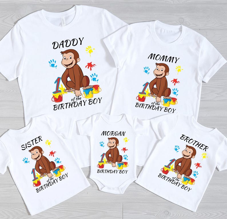 May include: White t-shirts and a onesie with a Curious George graphic. Each shirt has a different family member's name, the number 1, and the words "Birthday Boy". The shirts have colorful paint splatters.
