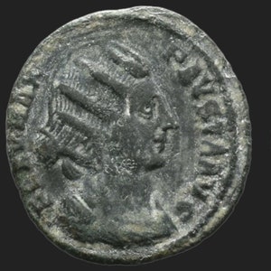 May include: A silver Roman coin with a portrait of a woman on one side. The coin has a raised rim and is in good condition.