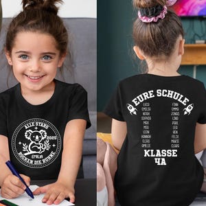 May include: Black t-shirt with white text that says "EURE SCHULE" and lists names. The text "KLASSE 4A" is below the names. A girl is wearing the shirt. Another black t-shirt with a koala graphic and the text "ALLE STARS 2025 ROCKEN DIE BUHNE" is shown.