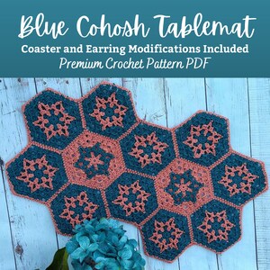 May include: A teal and peach crochet table mat with a hexagonal design. The table mat is made of yarn and has a snowflake pattern. The text "Blue Cohosh Tablemat Coaster and Earring Modifications Included Premium Crochet Pattern PDF" is at the top of the image.
