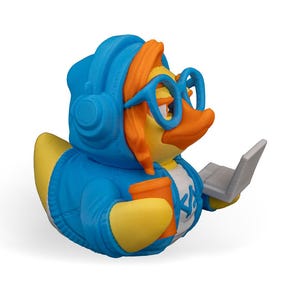 May include: A blue rubber duck wearing headphones, glasses, and a blue hoodie, holding a cup and a laptop.