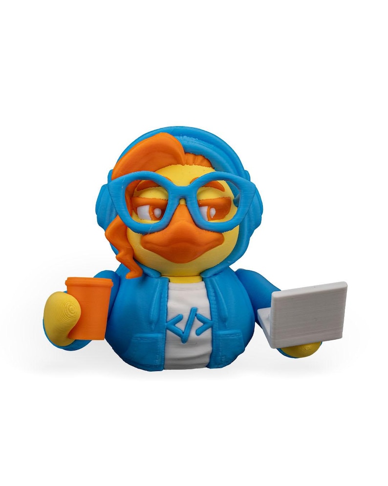 May include: A blue rubber duck wearing orange headphones and glasses, holding a cup of coffee and a laptop. The duck is wearing a blue hoodie with a white "</>" symbol on the front.