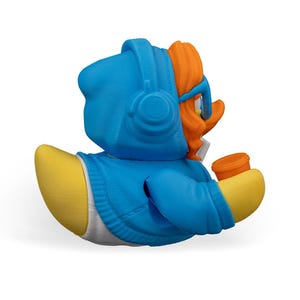 May include: A blue rubber duck wearing a blue hoodie with a white zipper and orange hair. The duck is holding a small orange cup in its right hand.