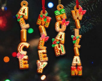 May include: Christmas-themed acrylic ornaments spelling out "MERRY CHRISTMAS". Each letter is designed to resemble a gingerbread cookie, adorned with icing, bows, and holly. The ornaments hang from red ribbons and gold cords.
