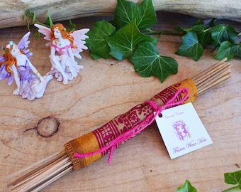 May include: A bundle of incense sticks wrapped in a colourful fabric with a pink ribbon. The label reads "Coconut Cream" and "Fairies Wear Hats".