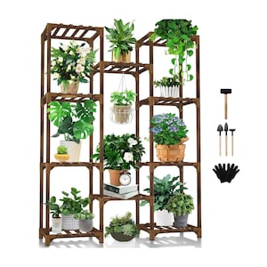 May include: A multi-tiered, dark brown wooden plant stand filled with various potted plants and flowers. The stand has a grid-like design with multiple shelves. Gardening tools and gloves are displayed to the right.
