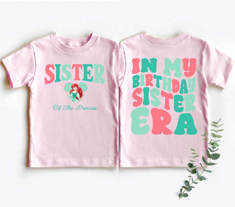two pink shirts with green and pink letters on them