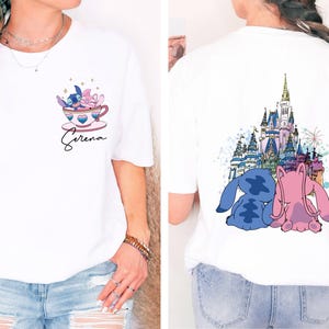 a woman wearing a white shirt with a castle on it