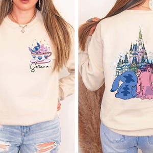 a woman wearing a sweatshirt with a castle on it
