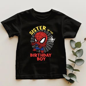 a spider - man birthday t - shirt on a table