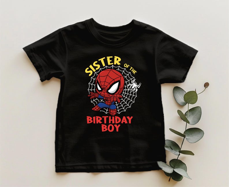 a spider - man birthday t - shirt on a table