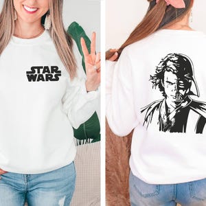 a woman wearing a sweatshirt with a star wars image on it